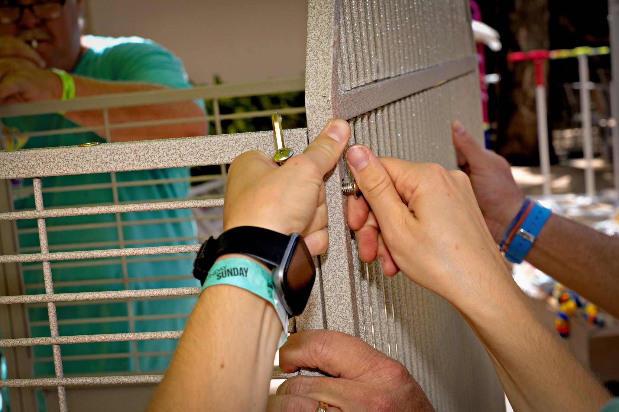 HFFN volunteers tightening bolts on a donated bird cage during the Maui wildfire relief effort